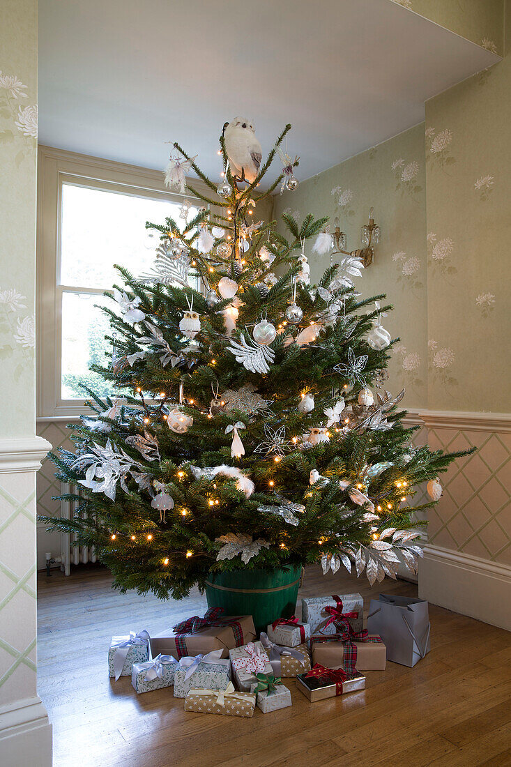 Christmas presents below tree in Sussex home England UK