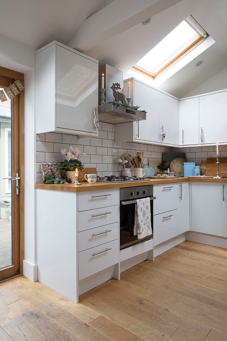 White fitted kitchen with skylight in London home England UK
