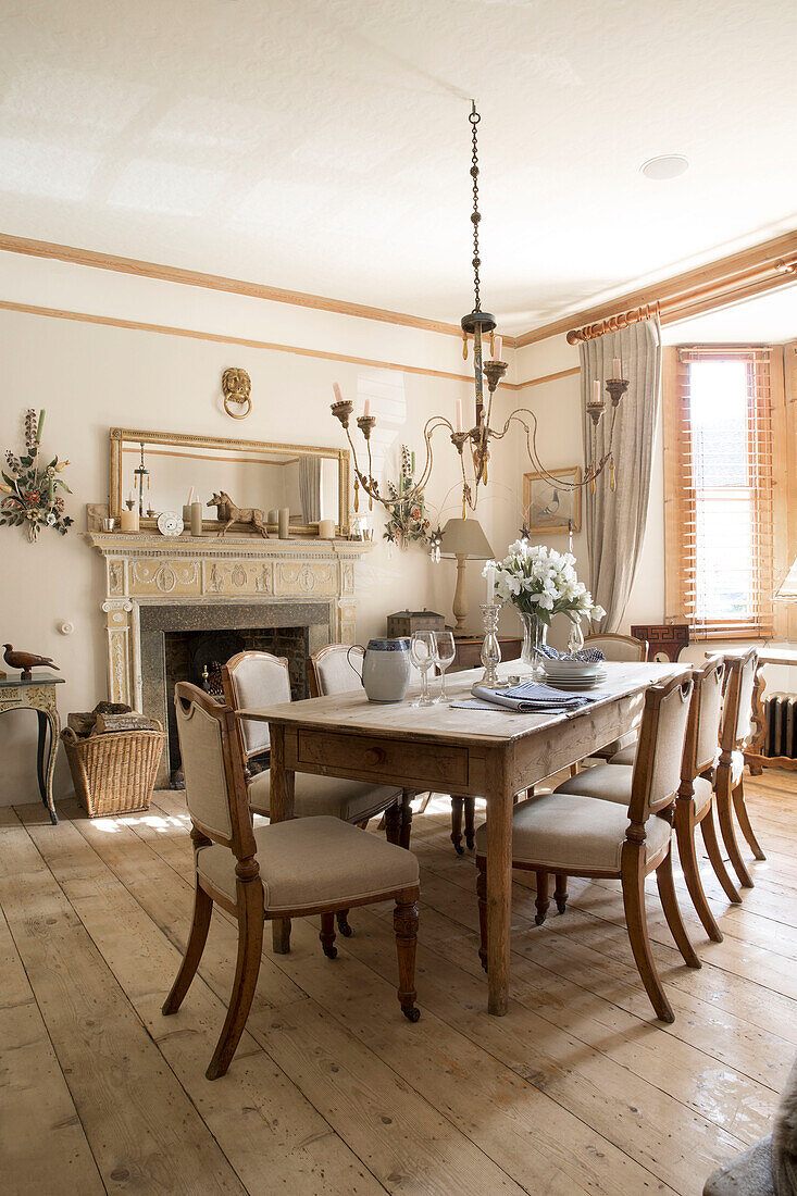Wooden dining table and chairs in Arundel home West Sussex England UK