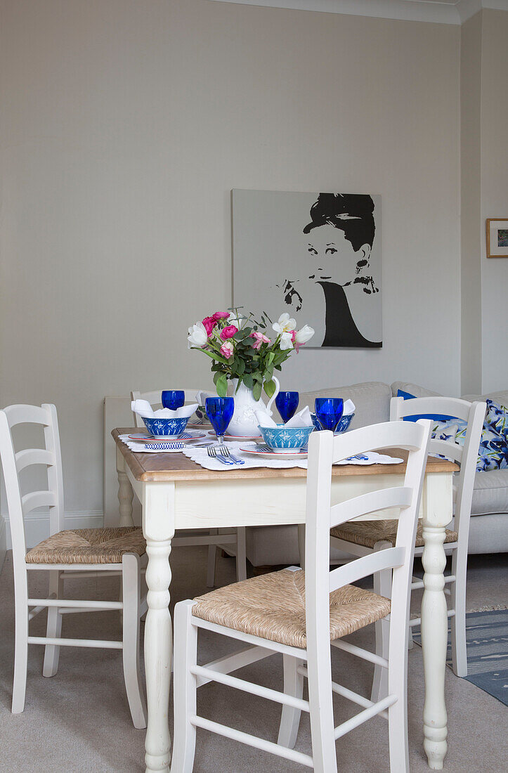 Kunstwerk auf Leinwand mit quadratischem Esstisch und Stühlen in einem Londoner Stadthaus UK