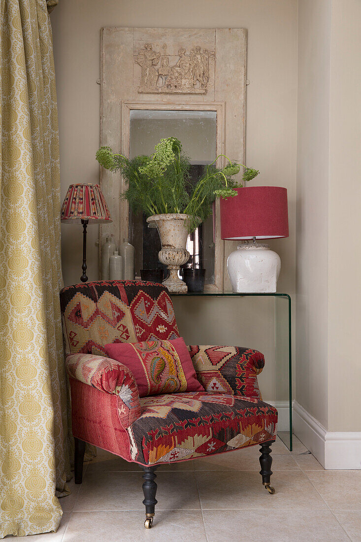 Tapestry covered armchair and fern in corner of Sussex home England UK