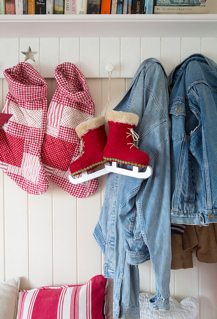Denim jackets and ice skates with Christmas stockings in South London family home England UK