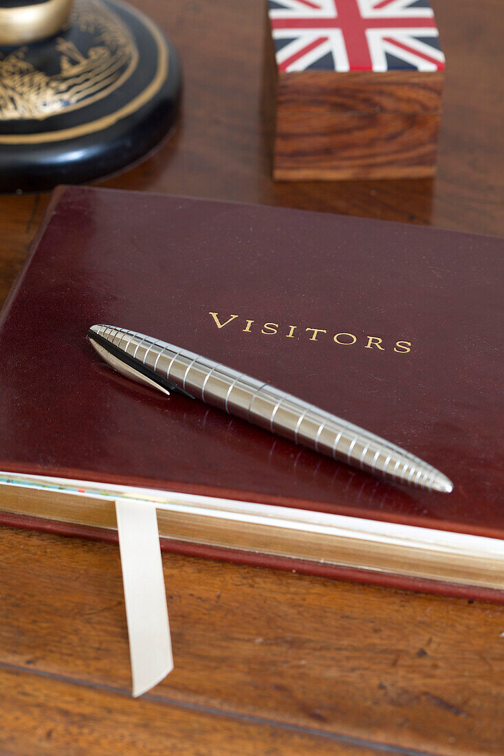 Rotes ledergebundenes Gästebuch mit silbernem Stift in einem Haus in Gloucestershire England UK