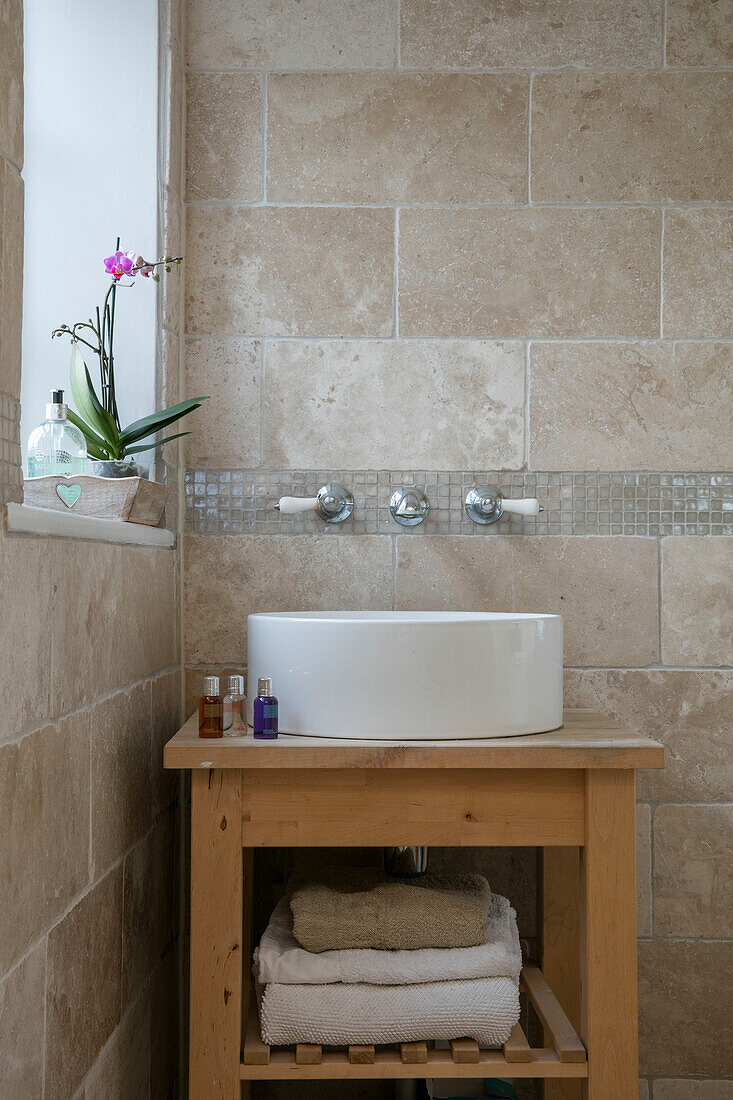 Circular washbasin on wooden washstand in West Sussex farmhouse UK