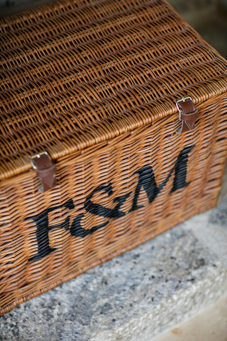 Wicker basket with letters 'F&M' in Gloucestershire barn conversion UK