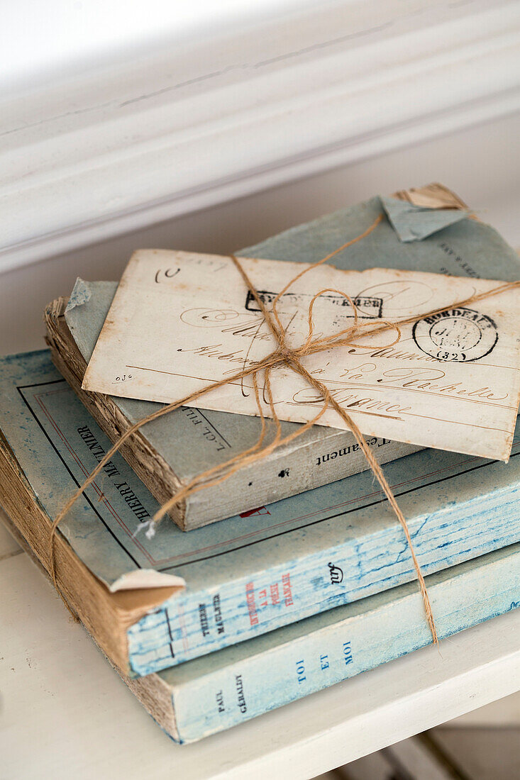 Postcard and books tied with string in Edwardian house Surrey UK