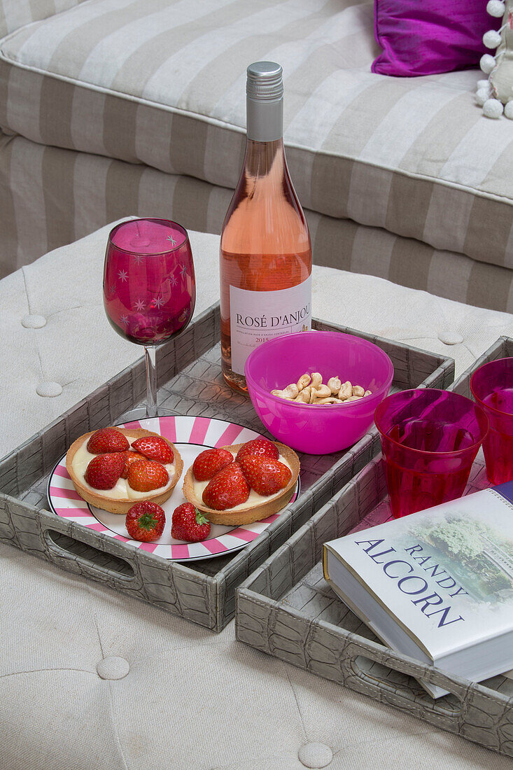 Rose wine with pink glassware and strawberry tarts on tray in Victorian terrace house South London UK