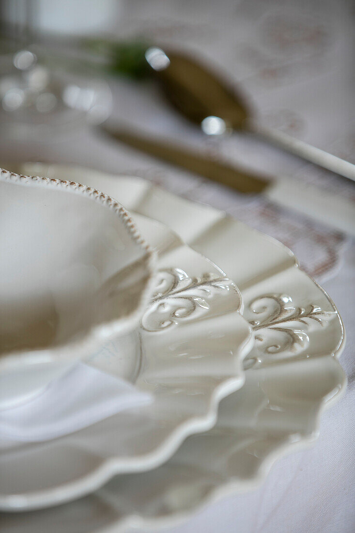 Decorative detail on white plates in detached Kent home UK
