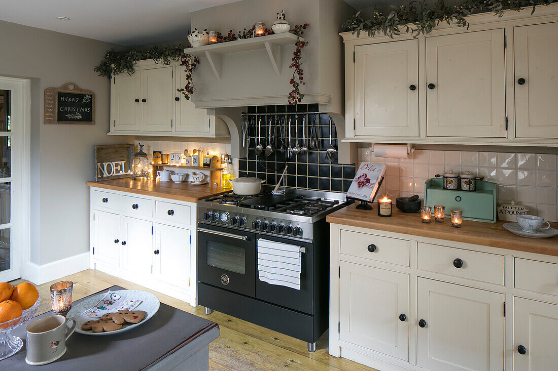 Christmas garlands above cupboard units in Hampshire kitchen