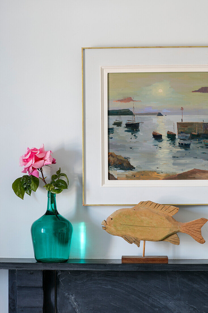 Framed seascape and single stem with wooden carved fish in Grade II listed cottage Cornwall UK