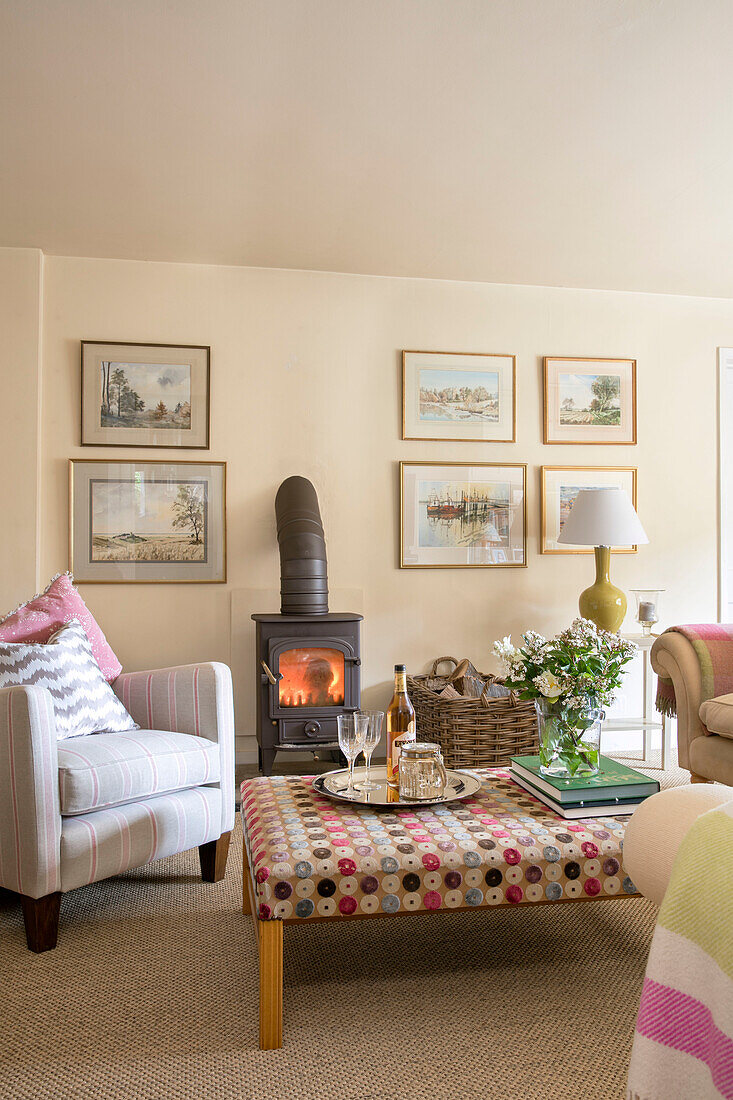 Ottoman and armchair with lit woodburner in Kent living room UK