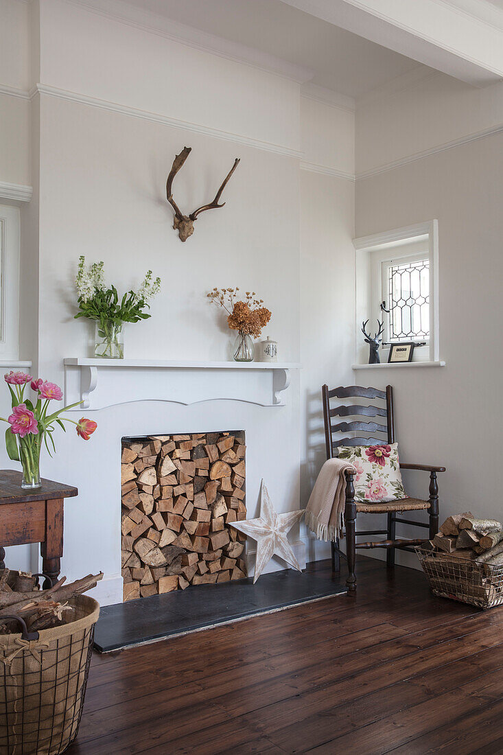 Firewood storage and cut flowers with original wooden floorboards in Grade II listed country house Hertfordshire UK