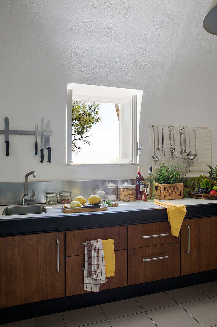 Wooden kitchen below open window in Italian villa on the Amalfi coast