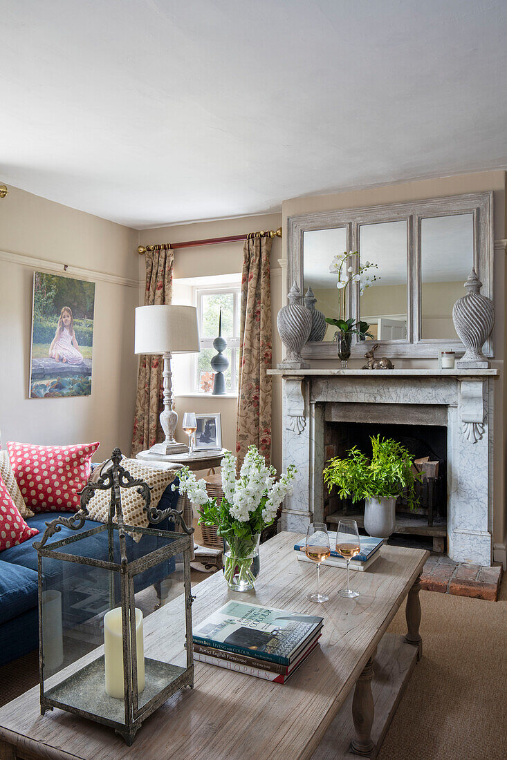 Urns on marble fireplace with lantern on coffee table in Grade II listed Georgian farmhouse Somerset, UK
