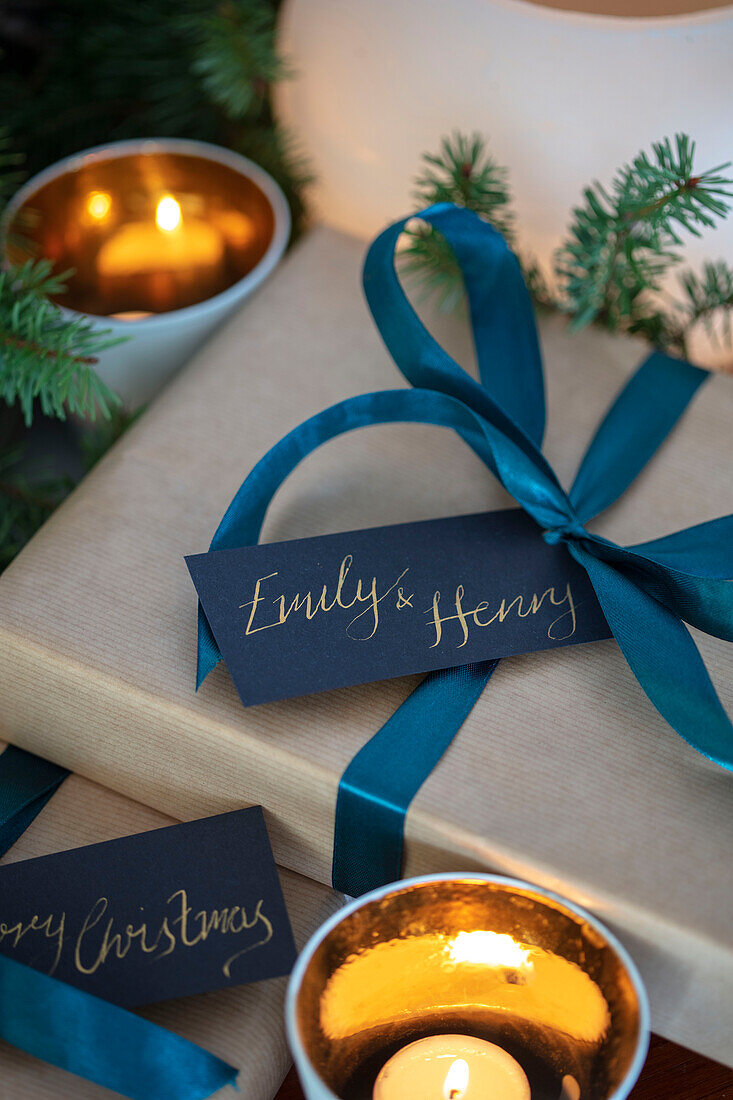 Present wrapped with teal ribbon and personalised gift tag in West Sussex UK