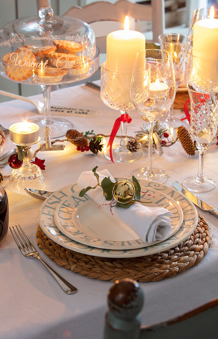 Candlelit Christmas place setting on table in Surrey home UK