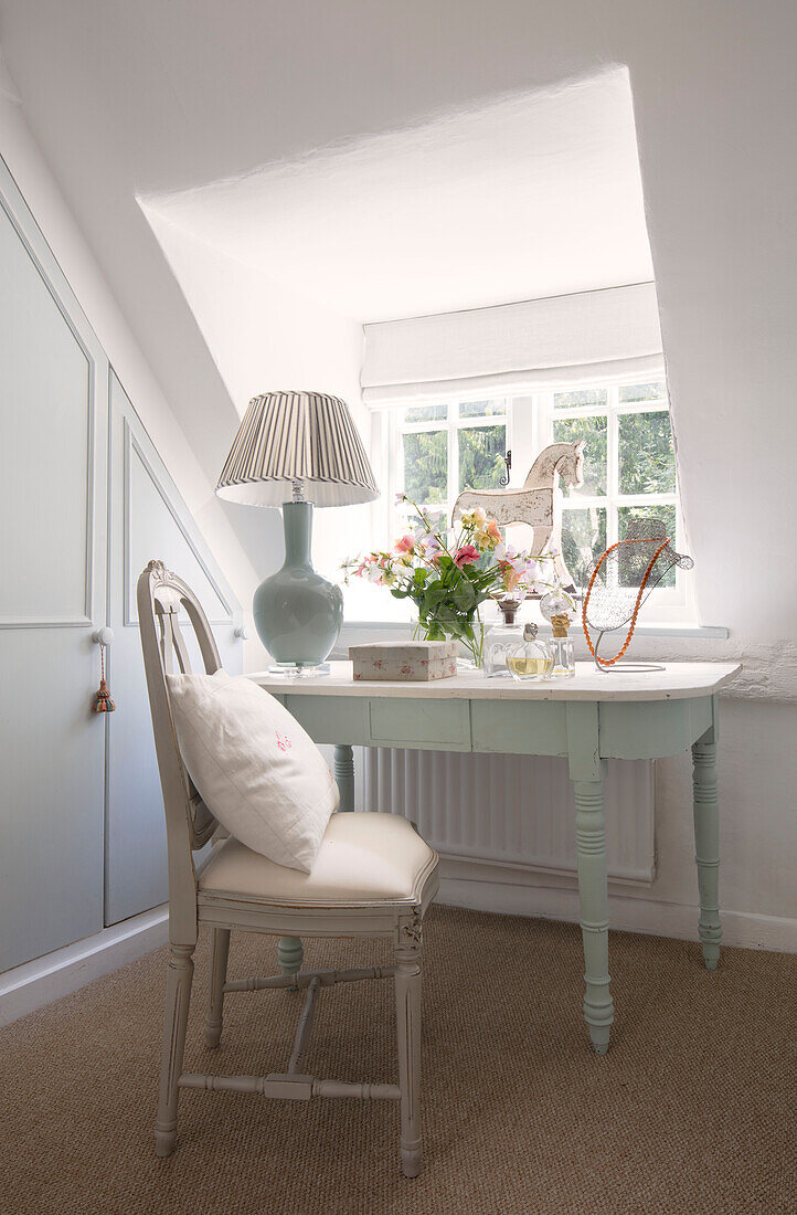 Dressing table and chair in dormer window of Surrey cottage UK