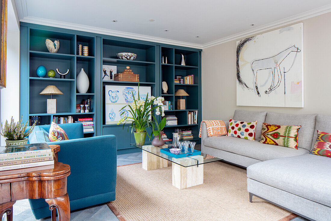 Teal sofa and shelving with corner sofa and glass topped coffee table London UK