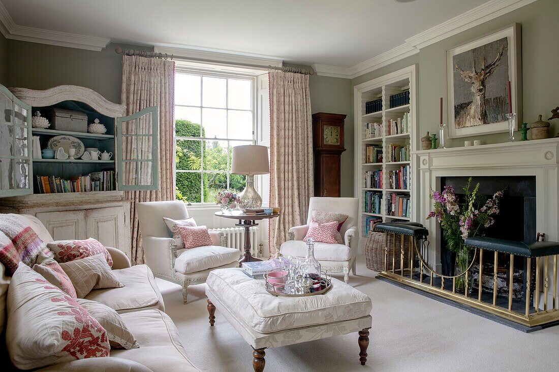 Elegant Living room with fresh cut flowers and pale pink and cream furnishings Hampshire UK