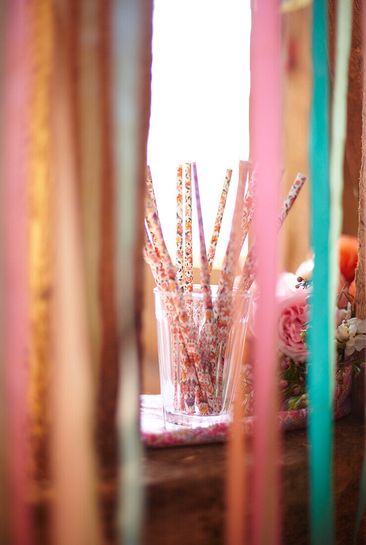 Drinking straws viewed through ribbon in late summer