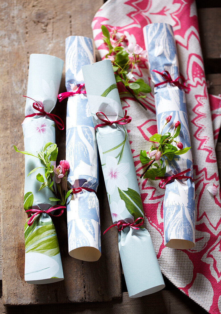 Homemade crackers from floral wallpaper tied with pink ribbon
