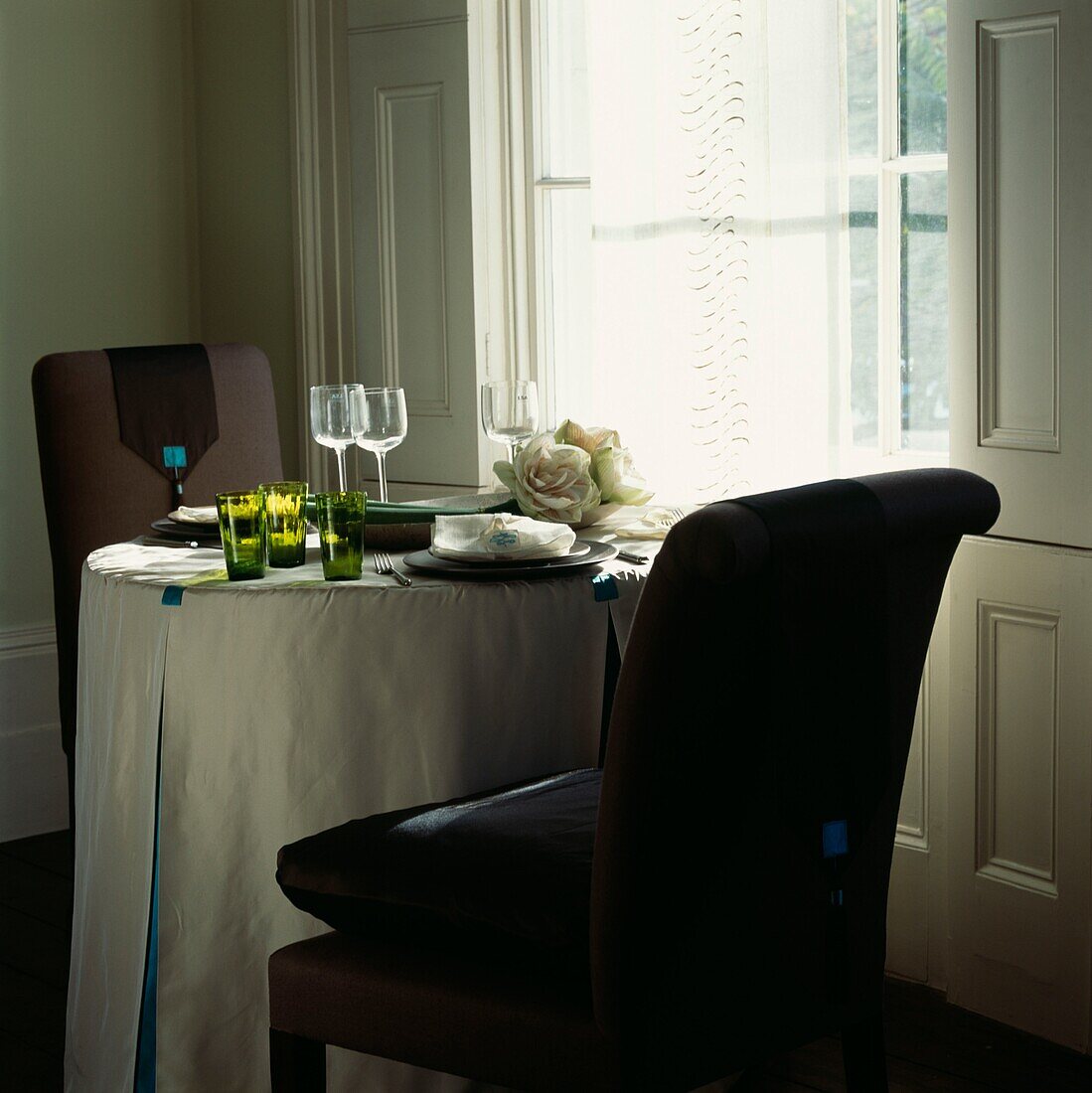 Dining room with large window and table setting for two