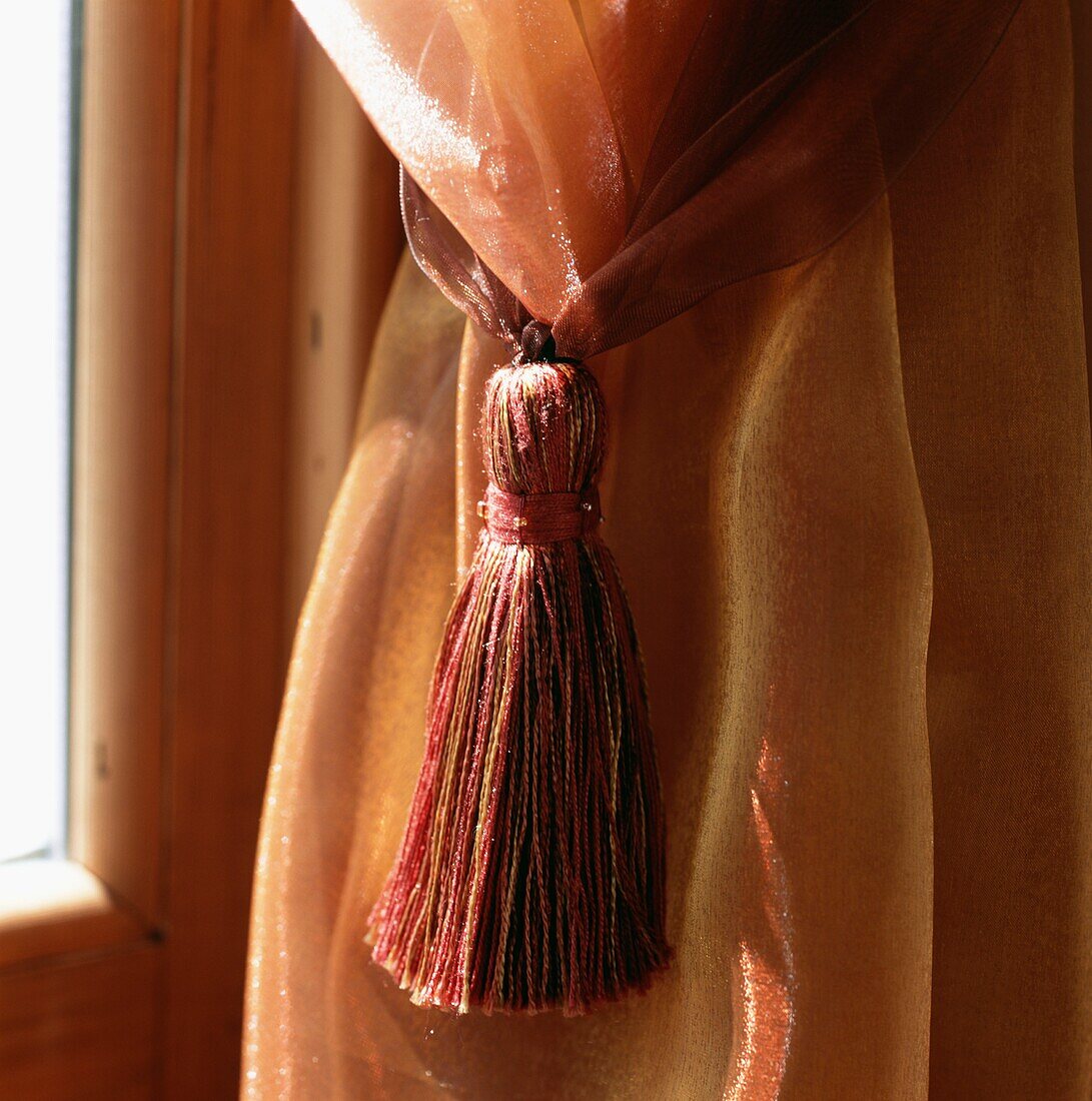 Window treatment curtain and tieback in orange colours