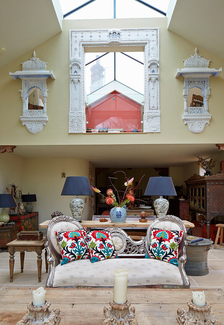 Living room with white vintage sofa and Indian wall shelves