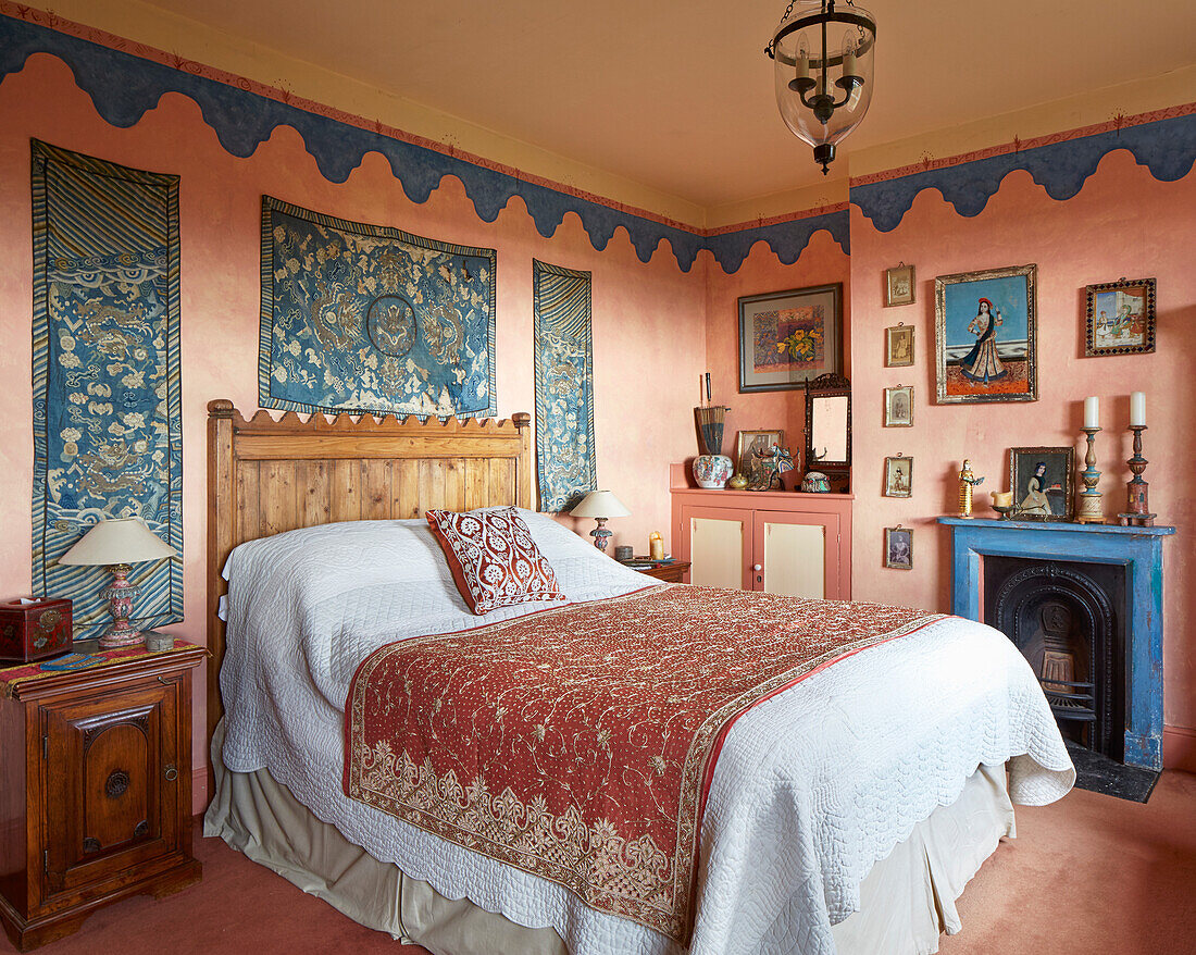 Bedroom with tapestries and rustic wooden bed, fireplace