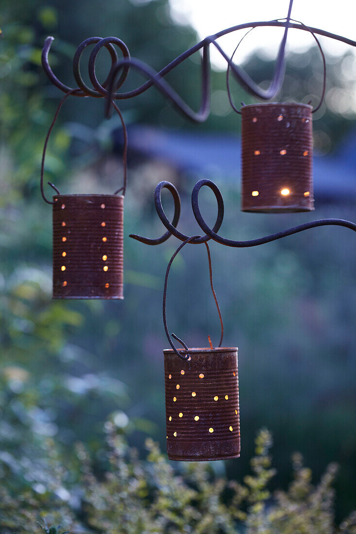 Handmade garden lanterns from old tin cans