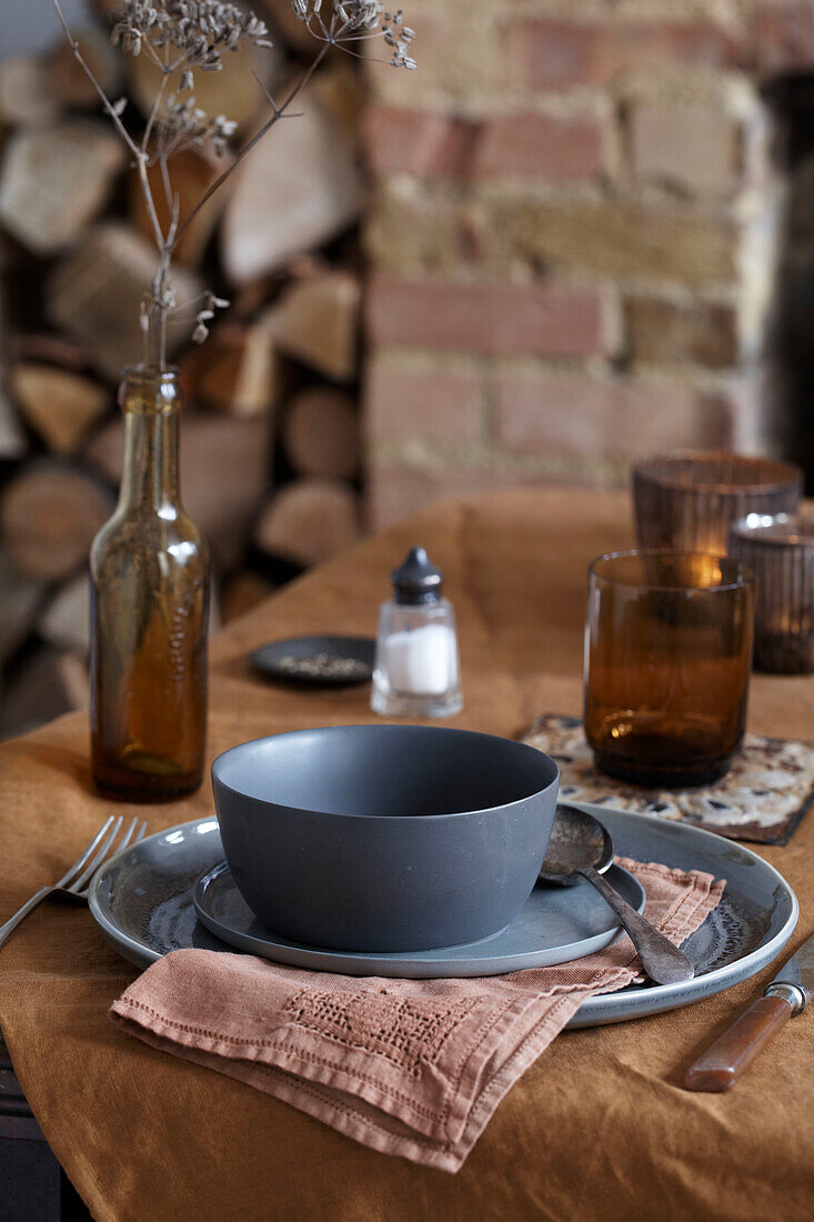 Set table with grey earthenware, rustic background