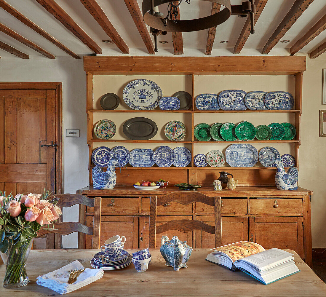 View over dining table to sideboard with decorative plates display