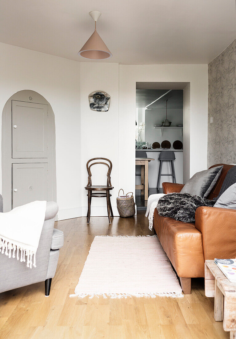 Living room with leather couch, carpet and wooden floor