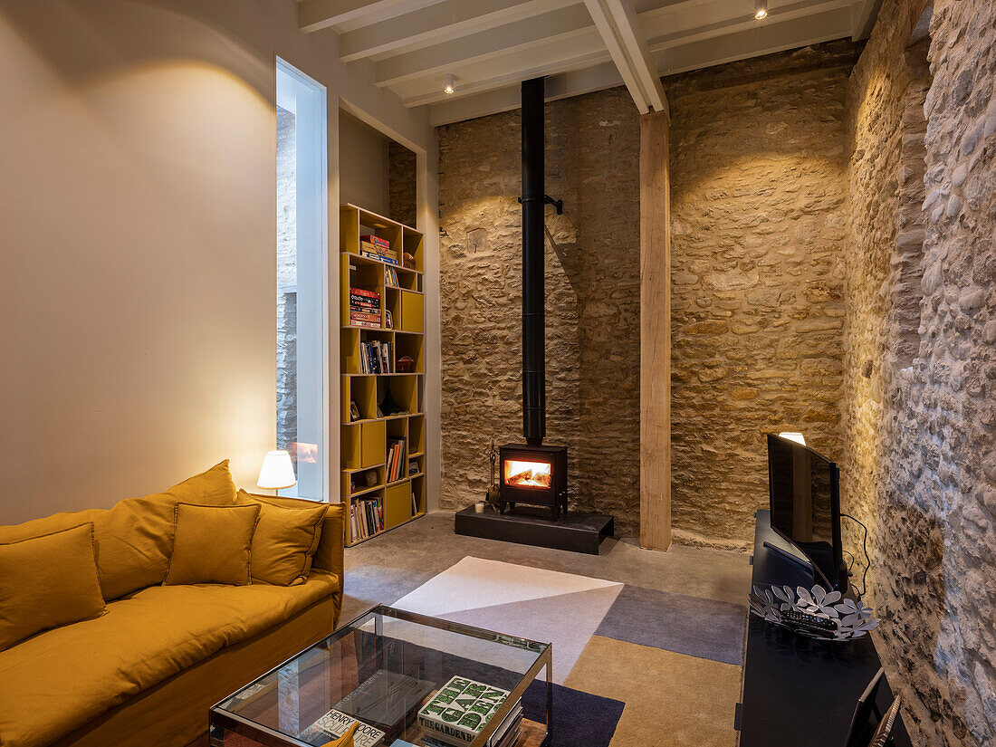 Lounge area with wood burning stove in a former barn