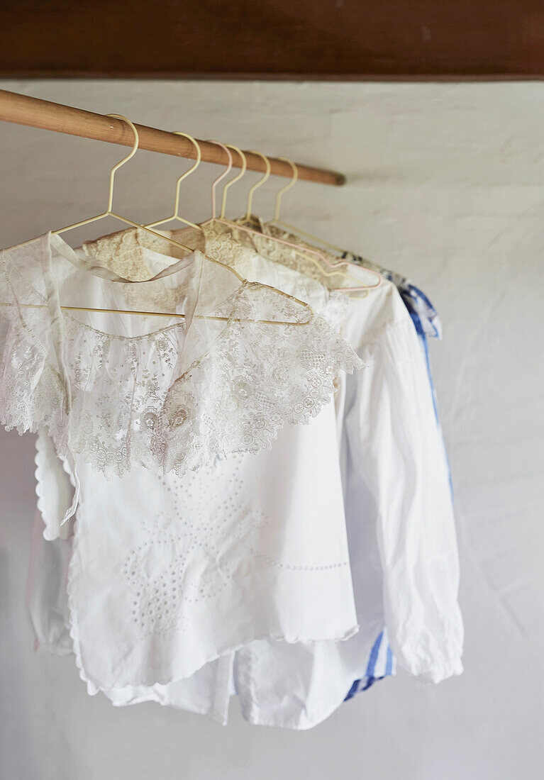 White lace blouses on hangers