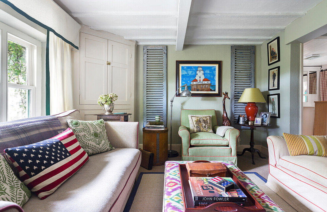 Colourful living room with patterned cushions and shutters with slats as decoration