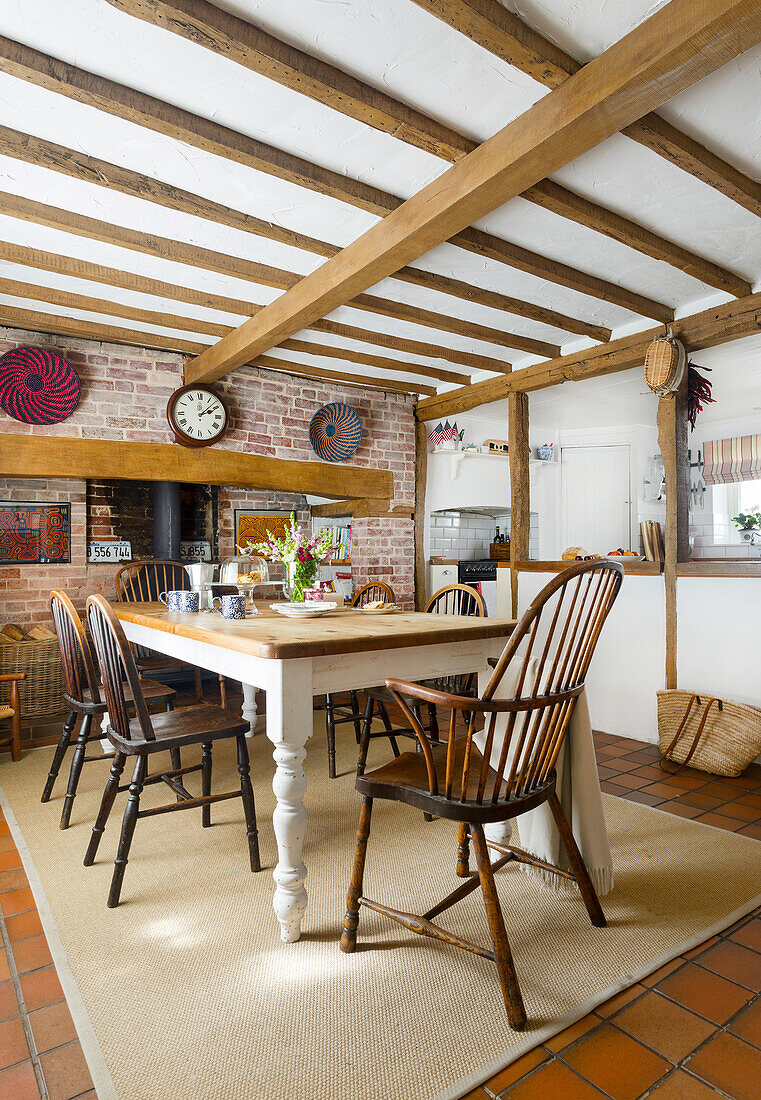 Country-style dining area with brick wall and wooden beams