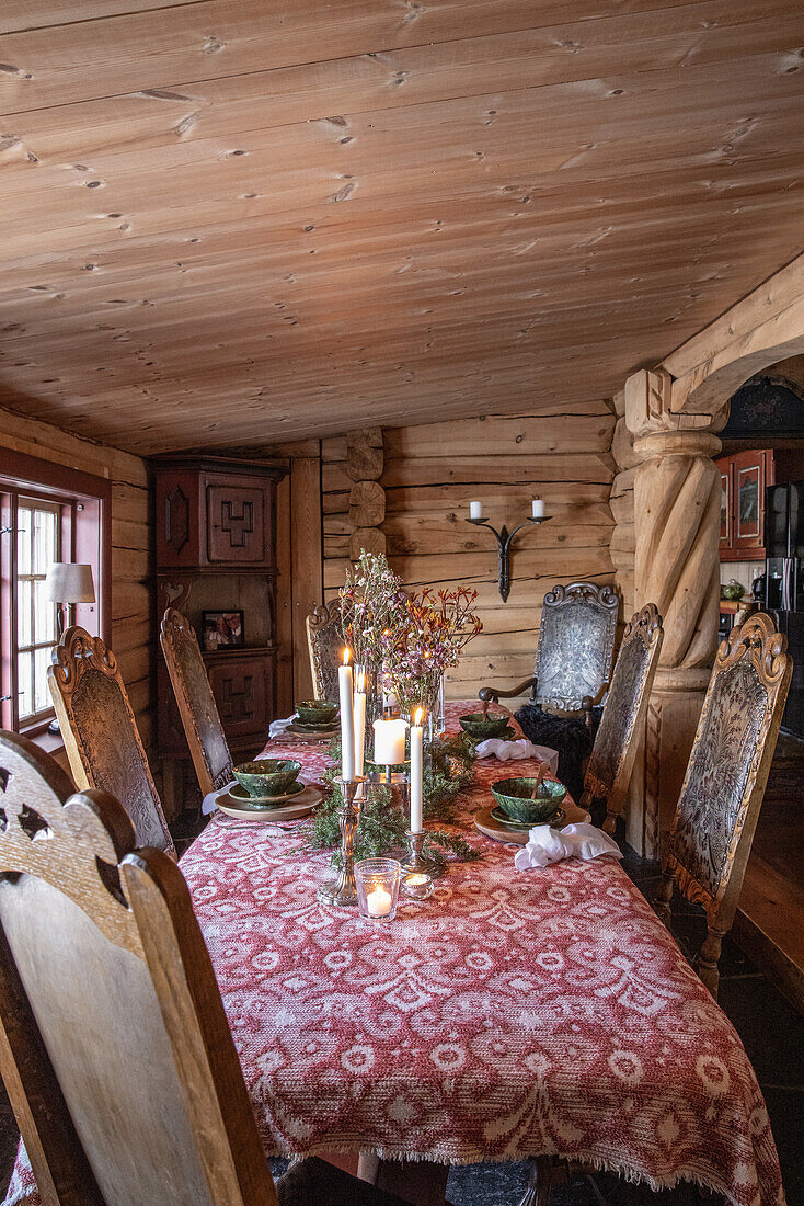 Set table in the rustic dining area of a log cabin