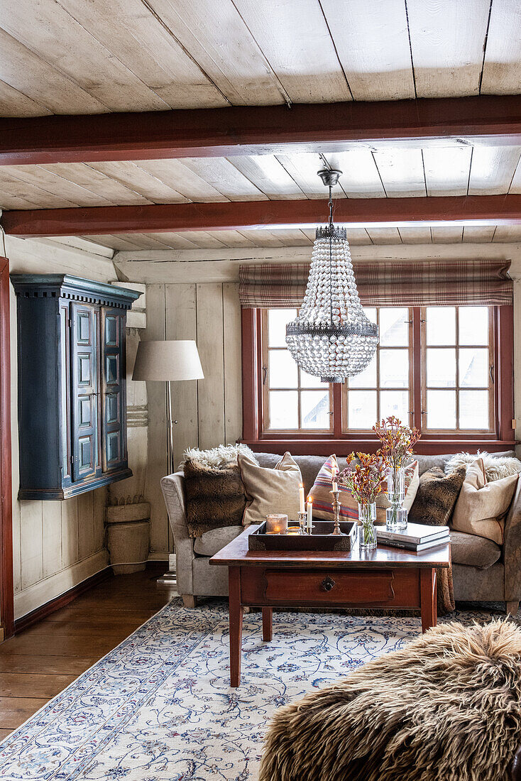 Rustic living room with crystal chandelier and antique furniture