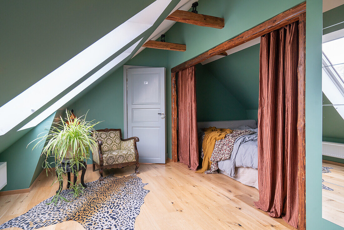 Attic bedroom with exposed beams and shades of green