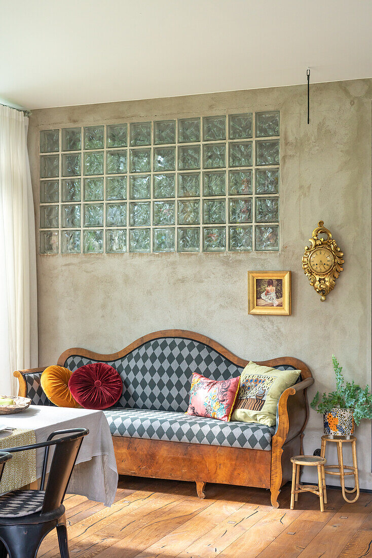 Bench with harlequin pattern, glass block wall and wooden floor