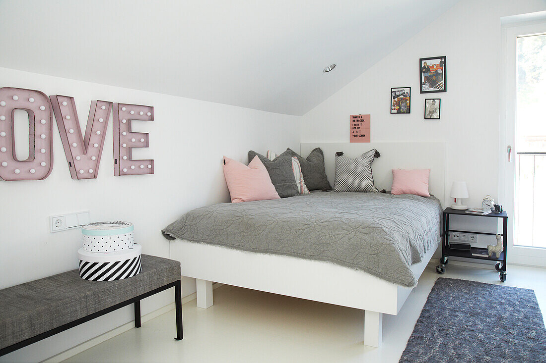 Attic bedroom with LOVE decorative letters and pink accents