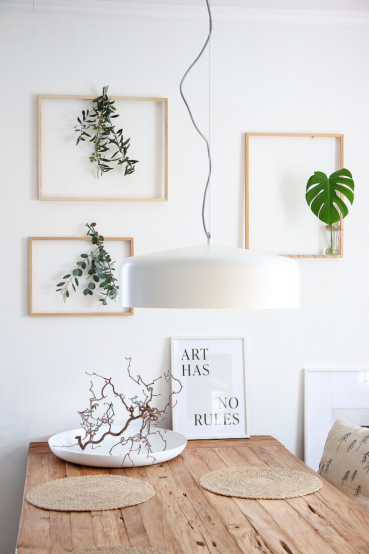 Bright dining room with plants in picture frames as wall decoration