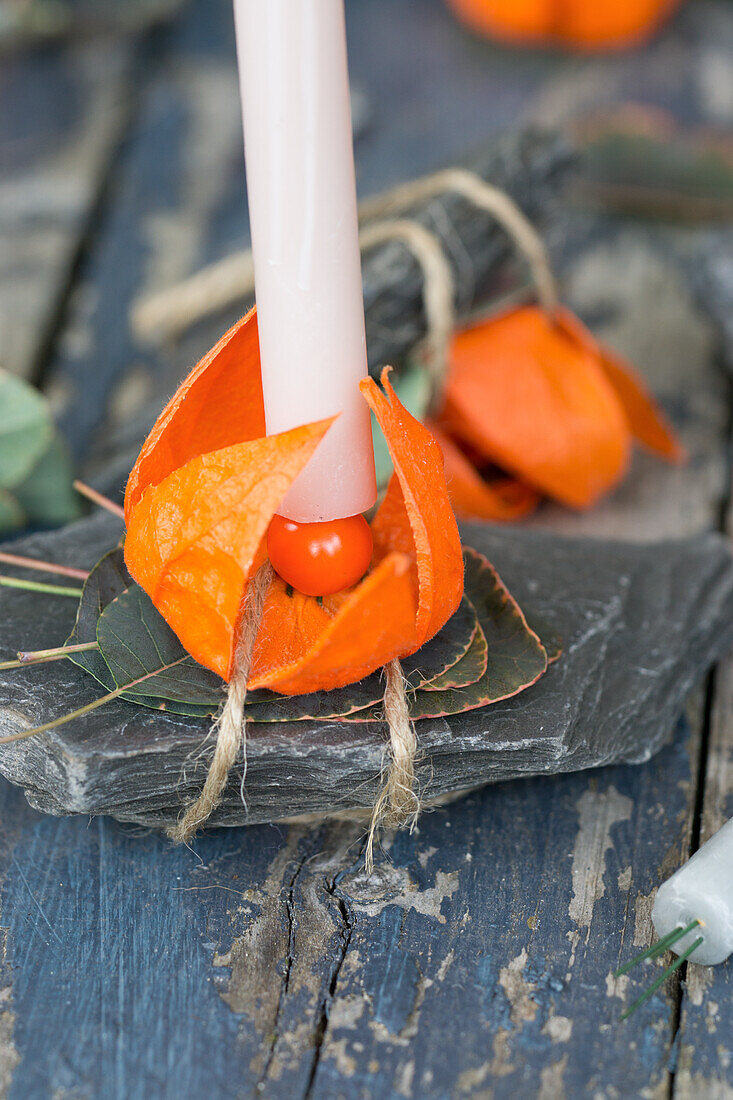 Candle in candle holder made of lantern flowers