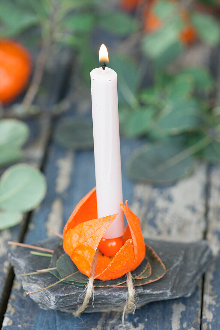 Candle in candle holder made of lantern flowers