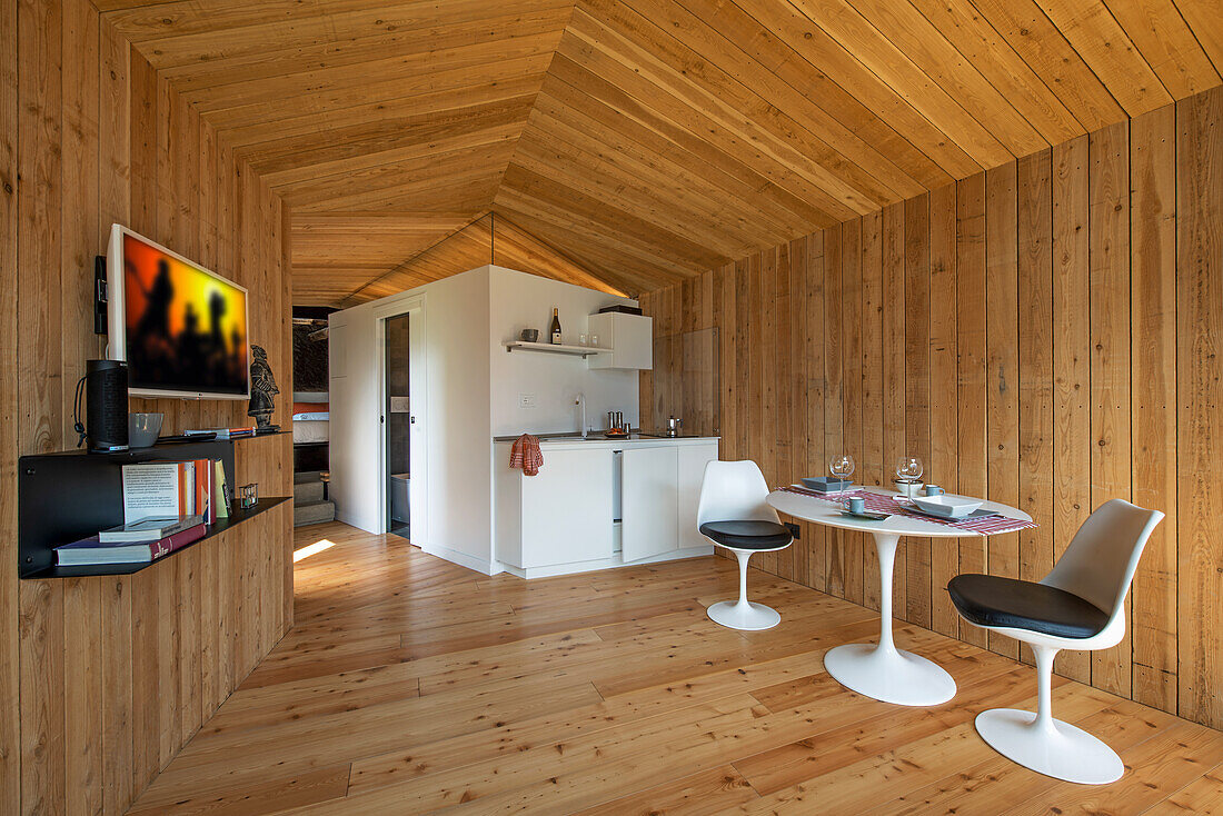 Modern chalet with wood paneling and tulip chairs