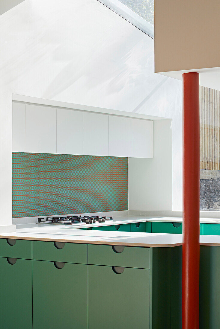 Custom-made kitchen with green cabinet fronts
