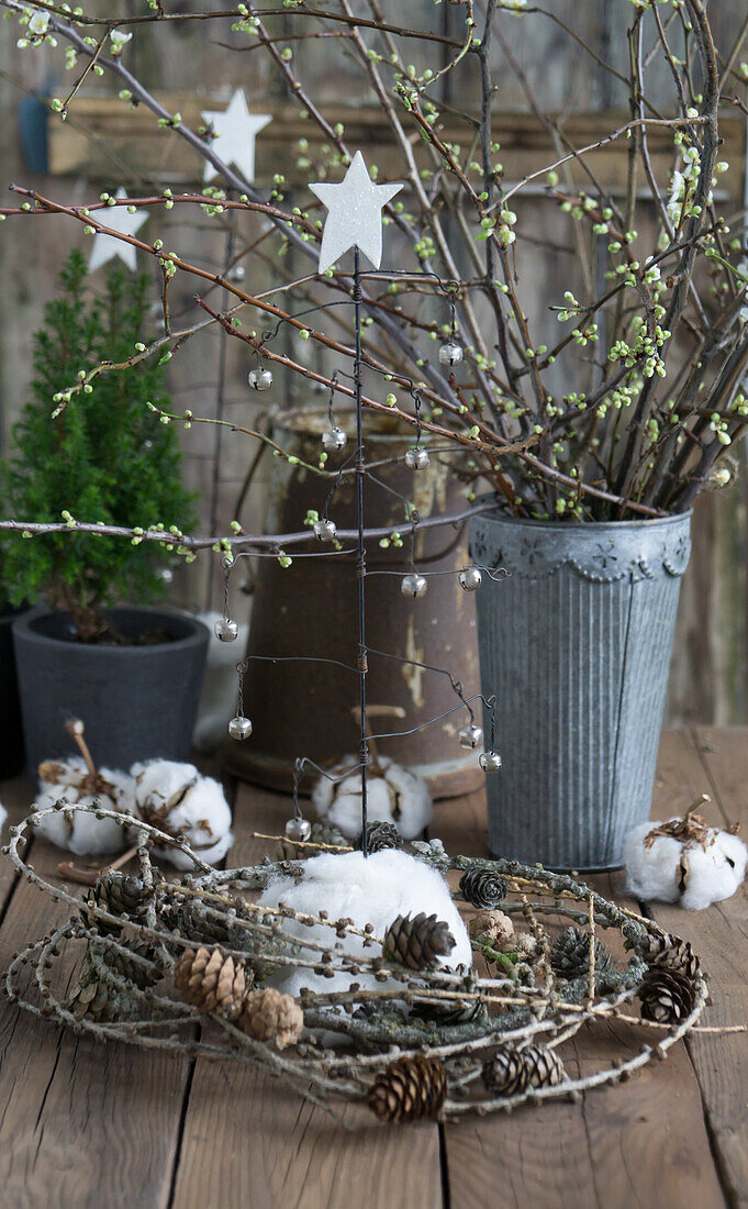 Plum blossom twigs and larch twigs in a zinc pot, fir tree, wire stars, and cotton