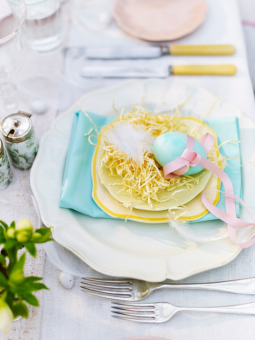 An Easter place setting with a blue coloured egg