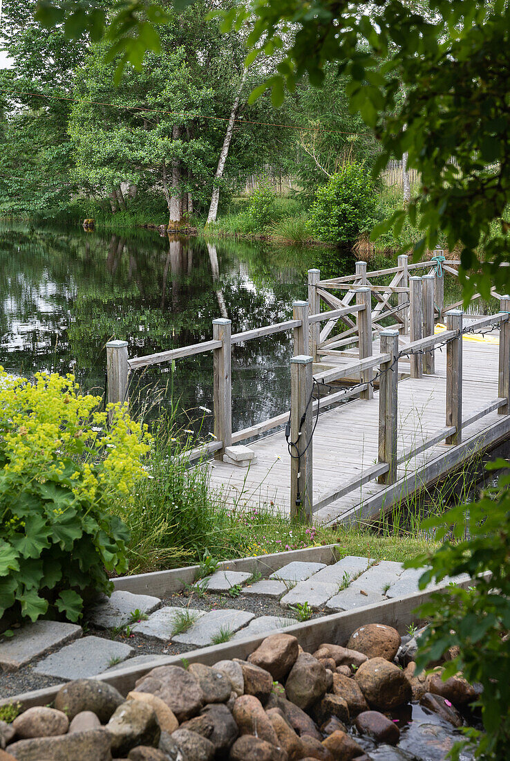 Garden pond with wooden footbridge
